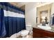 Bathroom features a granite countertop, modern lighting, and a shower/toilet area with a blue curtain at 15798 Weaver Gulch Dr, Morrison, CO 80465