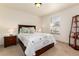 Comfortable bedroom features soft lighting, neutral carpet and a stylish quilt on the bed at 15798 Weaver Gulch Dr, Morrison, CO 80465