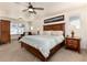 Comfortable bedroom with wood furniture, a ceiling fan, and a large bed, with natural light from the windows at 15798 Weaver Gulch Dr, Morrison, CO 80465