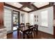 Charming dining room featuring a wood table and chairs, decorative ceiling beams and natural light from the patio doors at 15798 Weaver Gulch Dr, Morrison, CO 80465