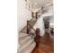 Welcoming foyer featuring a staircase with iron railings and hardwood floors at 15798 Weaver Gulch Dr, Morrison, CO 80465