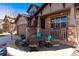 Inviting front porch with stone accents and comfortable seating, perfect for relaxing and enjoying the outdoors at 15798 Weaver Gulch Dr, Morrison, CO 80465