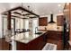 Large kitchen with granite countertops, dark wood cabinets, stainless steel appliances, and a dining area at 15798 Weaver Gulch Dr, Morrison, CO 80465
