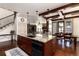 Gourmet kitchen featuring an island with seating, dark wood cabinets, and an open view to the living room at 15798 Weaver Gulch Dr, Morrison, CO 80465