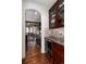Modern kitchen with wine cooler and granite countertops, hardwood floors and an archway leading to the dining area at 15798 Weaver Gulch Dr, Morrison, CO 80465
