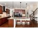 Spacious kitchen with dark wood cabinets, granite countertops, stainless steel appliances, and an open layout at 15798 Weaver Gulch Dr, Morrison, CO 80465