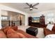 Spacious upstairs living room with a comfortable seating area, plush ottoman, and stairs leading to the main floor at 15798 Weaver Gulch Dr, Morrison, CO 80465
