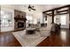 Comfortable living room with stone fireplace, coffered ceiling, and wood floors, with a view into the dining room at 15798 Weaver Gulch Dr, Morrison, CO 80465