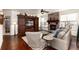 Inviting living room with a cozy stone fireplace, ceiling fan, built-in shelving, and an open floor plan at 15798 Weaver Gulch Dr, Morrison, CO 80465