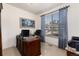 Functional office space with large wooden desk and a comfortable chair, with natural light from the window at 15798 Weaver Gulch Dr, Morrison, CO 80465