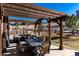 Inviting covered patio with outdoor seating and dining area; perfect for relaxing and entertaining at 15798 Weaver Gulch Dr, Morrison, CO 80465