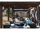 Comfortable outdoor space with couches, fire pit, grill, and fireplace for entertainment and relaxing at 15798 Weaver Gulch Dr, Morrison, CO 80465