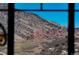 Through the window is a scenic view of the mountainous red rocks with a clear blue sky at 15798 Weaver Gulch Dr, Morrison, CO 80465
