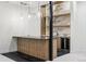 Modern bar with custom shelving, sleek countertops, and a beverage cooler at 2960 E Floyd Dr, Denver, CO 80210
