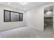 Bedroom with a full bathroom, a window, and neutral carpeted floors at 2960 E Floyd Dr, Denver, CO 80210