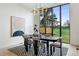 Modern dining room featuring stylish lighting fixture and views of outdoor scenery at 2960 E Floyd Dr, Denver, CO 80210