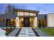 Contemporary home entrance with a stone walkway, modern door, and manicured landscaping at 2960 E Floyd Dr, Denver, CO 80210