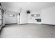 Expansive garage space with a large roll-up door, concrete floors, and ample natural light from modern windows at 2960 E Floyd Dr, Denver, CO 80210