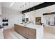 Bright, open kitchen with marble counters, stainless appliances, a large island, and an open floorplan at 2960 E Floyd Dr, Denver, CO 80210