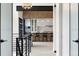 View of kitchen from hallway featuring modern cabinetry, bar stool seating, and stainless steel appliances at 2960 E Floyd Dr, Denver, CO 80210