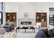Spacious living room with fireplace, built-in bookshelves, and modern decor at 2960 E Floyd Dr, Denver, CO 80210
