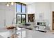 Bright open living space with fireplace, high ceilings, large windows, and sleek modern finishes at 2960 E Floyd Dr, Denver, CO 80210