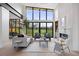 Sun-filled living room featuring floor-to-ceiling windows, fireplace, and contemporary furnishings at 2960 E Floyd Dr, Denver, CO 80210
