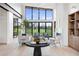 Bright living room featuring a fireplace, hardwood floors, modern lighting, and oversized windows with a view at 2960 E Floyd Dr, Denver, CO 80210
