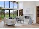 Bright living room featuring large windows, built-in shelving, fireplace, and open floor plan at 2960 E Floyd Dr, Denver, CO 80210