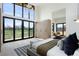 Bright main bedroom with exterior views, natural wood accents, and contemporary furnishings at 2960 E Floyd Dr, Denver, CO 80210