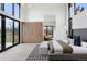 Bright main bedroom featuring exterior views, natural wood accents, and contemporary furnishings at 2960 E Floyd Dr, Denver, CO 80210