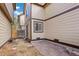 The backyard has a stone patio area surrounded by beige siding townhouses and a wooden fence at 1816 S Pagosa Way # 5, Aurora, CO 80017