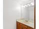Bathroom featuring white walls, a wood vanity and a well-lit mirror at 1816 S Pagosa Way # 5, Aurora, CO 80017