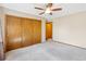 Bedroom with a ceiling fan, neutral carpet, and a closet with wooden sliding doors at 1816 S Pagosa Way # 5, Aurora, CO 80017