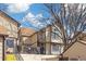 Two-story townhome featuring neutral siding with brown trim, a walkway, and stairs to the front door at 1816 S Pagosa Way # 5, Aurora, CO 80017