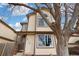 Charming two-story home with neutral siding, brown trim, and a large tree in the front yard at 1816 S Pagosa Way # 5, Aurora, CO 80017