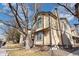 Two-story home with neutral siding and brown trim surrounded by mature trees at 1816 S Pagosa Way # 5, Aurora, CO 80017
