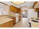 Cozy kitchen with wooden cabinets, white appliances, and a sliding glass door to the backyard at 1816 S Pagosa Way # 5, Aurora, CO 80017