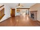 Spacious living room with hardwood floors, brick fireplace, and an open floor plan connecting to kitchen at 1816 S Pagosa Way # 5, Aurora, CO 80017