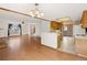 Open floor plan with hardwood floors, a dining area, and a view into the kitchen at 1816 S Pagosa Way # 5, Aurora, CO 80017
