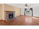 Living room featuring a brick fireplace, hardwood floors, and a window with natural light at 1816 S Pagosa Way # 5, Aurora, CO 80017