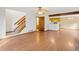 View of a living room featuring hardwood floors, a staircase, and an open floor plan leading to kitchen at 1816 S Pagosa Way # 5, Aurora, CO 80017