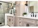 Close up on bright dual vanities in a bathroom with a glass shower in the background at 1685 S Milwaukee St, Denver, CO 80210