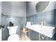 Elegant powder room with patterned wallpaper, stylish sink, and modern fixtures at 1685 S Milwaukee St, Denver, CO 80210