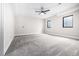 Minimalist carpeted bedroom with two windows and a ceiling fan at 1685 S Milwaukee St, Denver, CO 80210