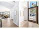 Bright entryway with a modern door, hardwood floors, high ceilings, and a view into the dining room at 1685 S Milwaukee St, Denver, CO 80210