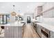 Spacious kitchen with a large center island, modern appliances, light wood floors, and pendant lighting at 1685 S Milwaukee St, Denver, CO 80210