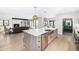 Open-concept kitchen with an island, stainless steel appliances, and a view into the living room at 1685 S Milwaukee St, Denver, CO 80210
