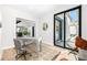 Bright office featuring light wood floors, a rustic desk, and a sliding glass door to the outside at 1685 S Milwaukee St, Denver, CO 80210