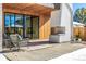 Modern covered patio with an outdoor fireplace, wood accents, and stylish patio furniture at 1685 S Milwaukee St, Denver, CO 80210